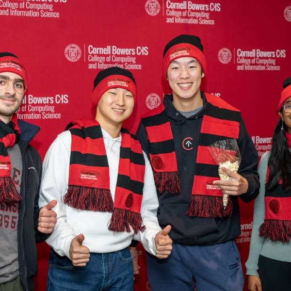A color photo of four Cornell students